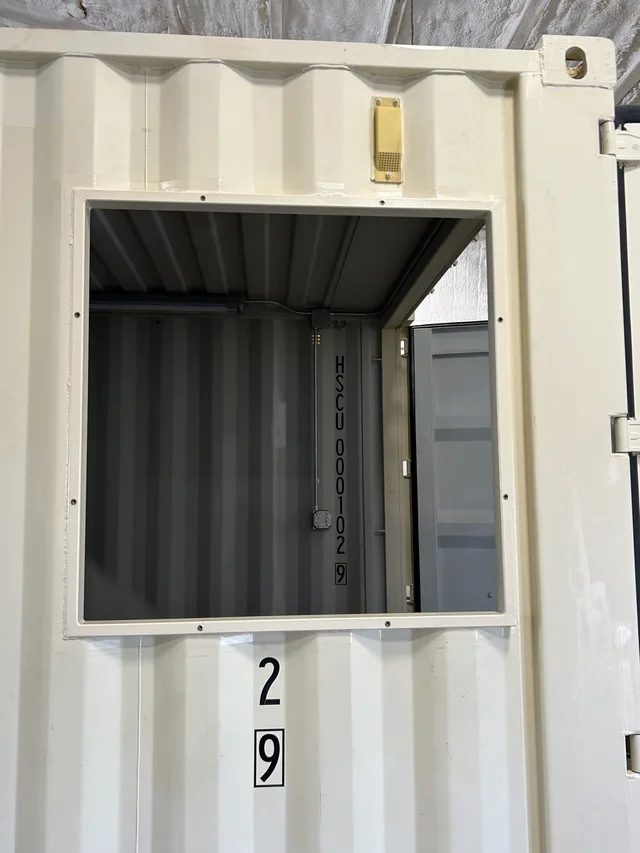 Side-access panel on a generator housing for maintenance access