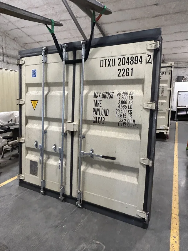 Container modification with roof-mounted solar panel brackets