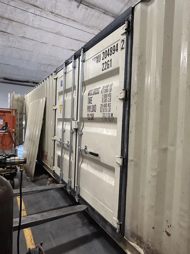 Container modification showing exterior conduit and light fixture mount