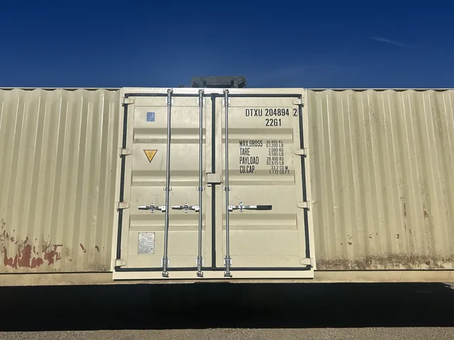 Container modification with roll-up door and weather stripping detail