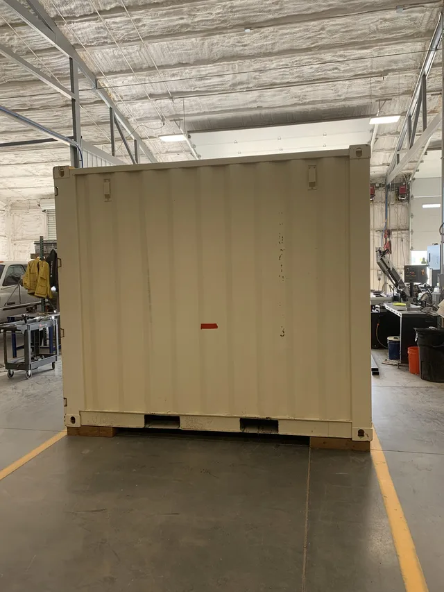 Custom container build at Hercules shop — framing stage complete