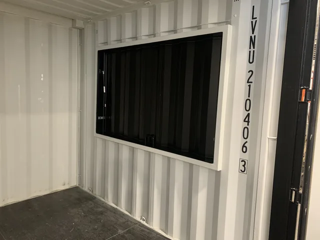 Container modification in progress — wall panels being installed