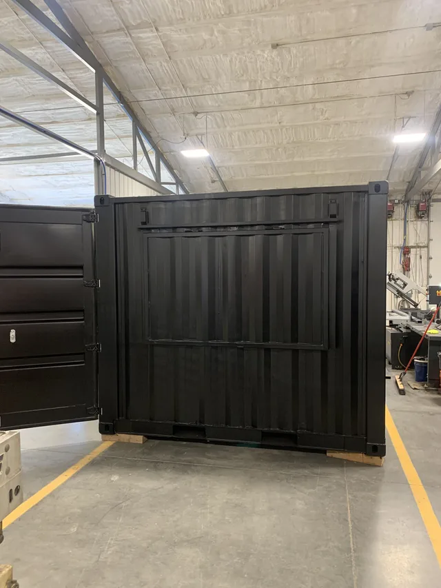 Modified container with fold-down service counter for retail use