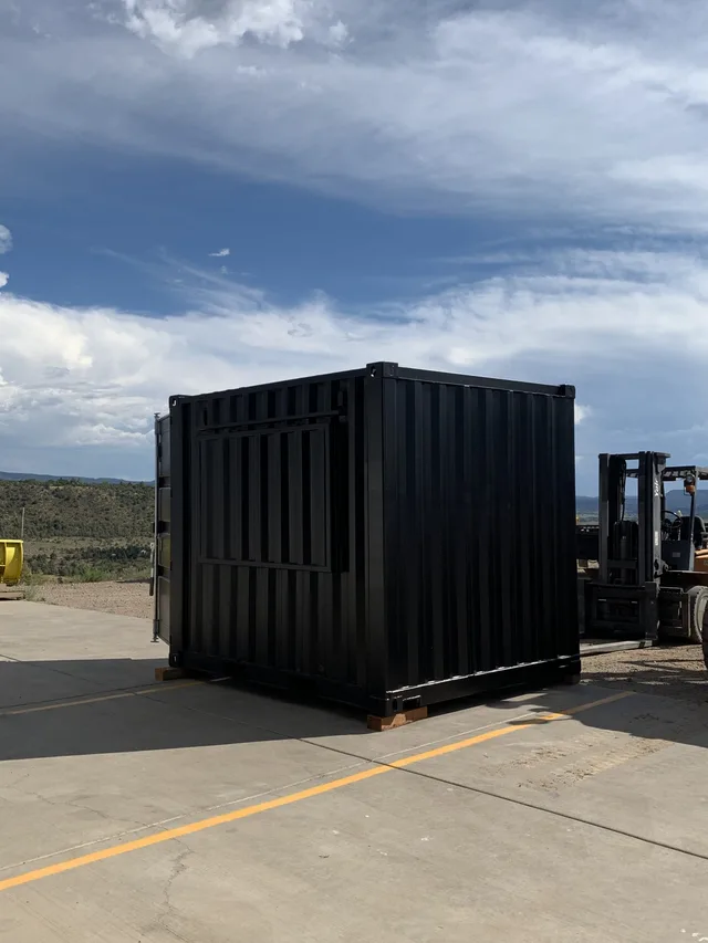 Steel reinforcement plate welded to a container wall for mounting