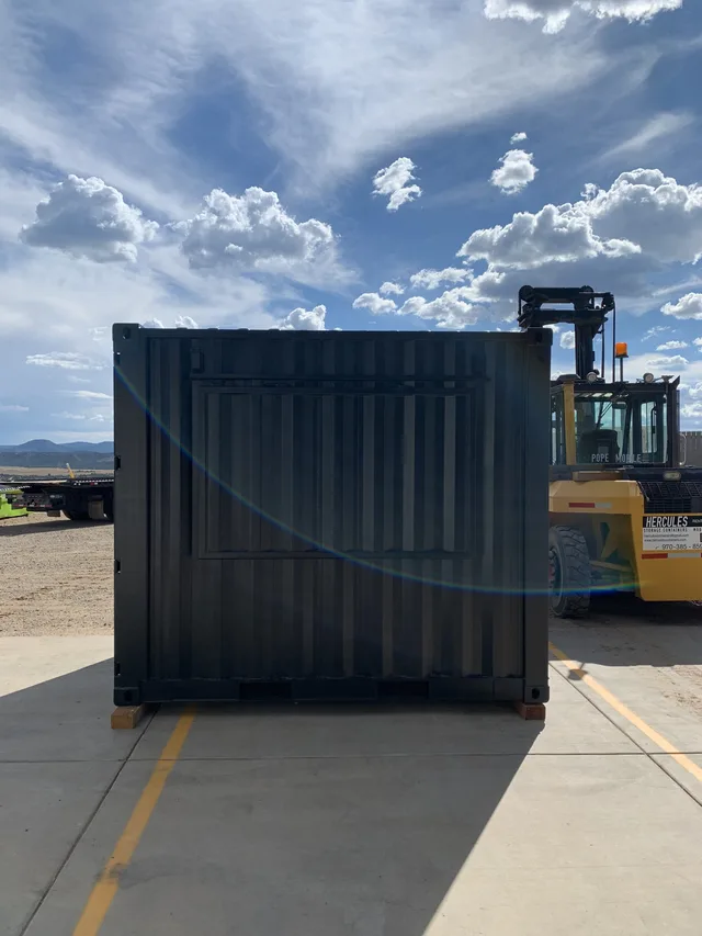 Container modification with sliding glass door installation