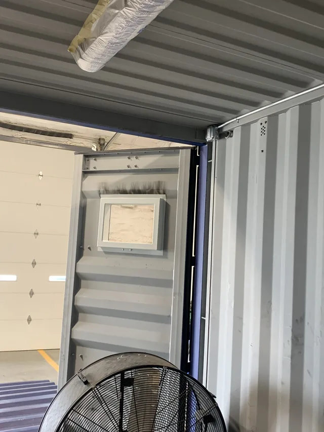 Container modification progress showing steel framing and cutouts