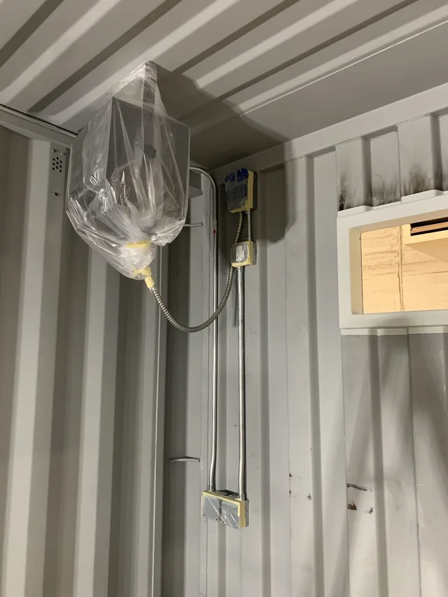 Roll-up door mechanism detail on a modified storage container