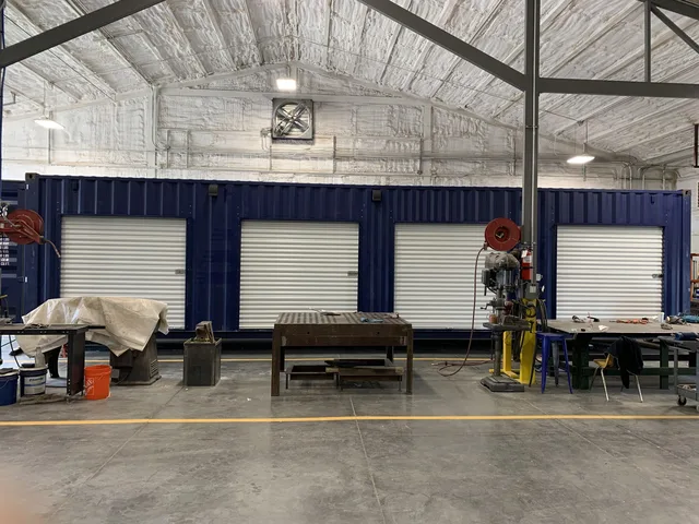 Container modification showing HVAC unit mounted on exterior wall