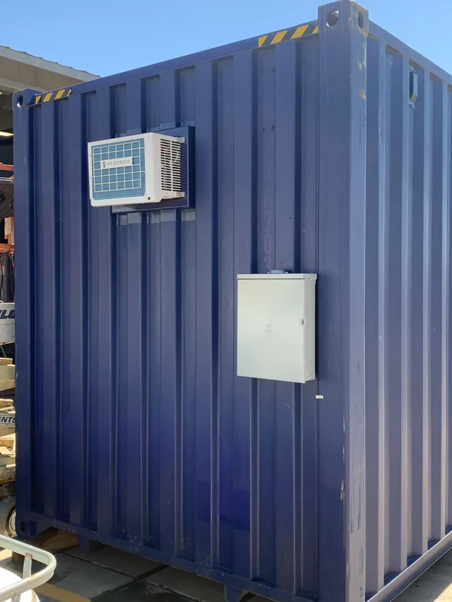 Container with built-in generator compartment and sound barrier wall