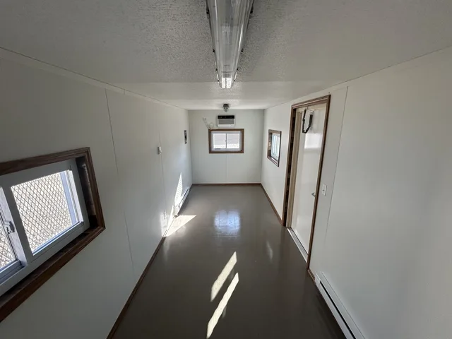 Interior view of a 20-foot container office conversion with finished walls