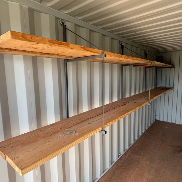 Container positioned on a prepared foundation pad at a customer site