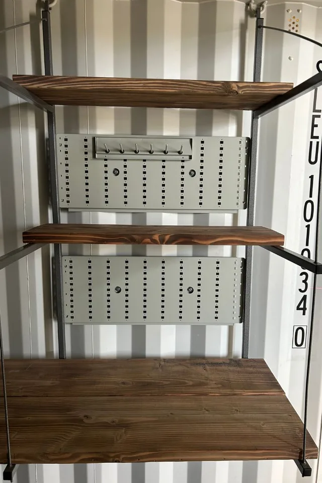 Container shelving unit with wire deck panels for ventilation